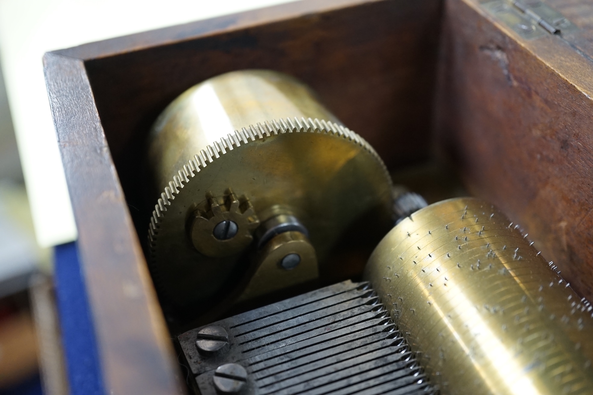 A small mid 19th century Swiss musical box in a bird’s eye maple case, side key wound, 30cm wide. Condition - fair.